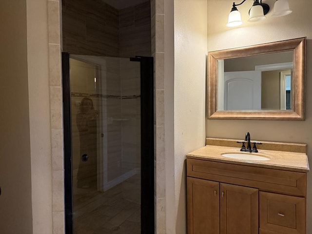 bathroom with vanity and a shower with shower door