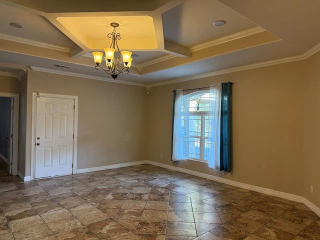 spare room with a raised ceiling, crown molding, and a chandelier