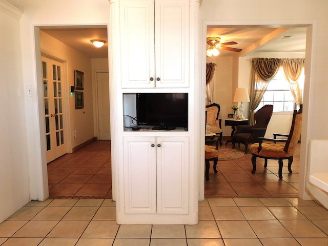 kitchen with light tile patterned floors, french doors, white cabinetry, and ceiling fan