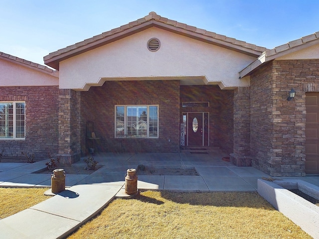 entrance to property with a patio area