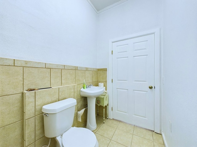 bathroom featuring tile walls, tile patterned flooring, crown molding, and toilet