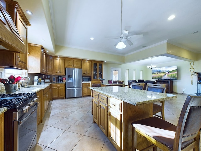 kitchen featuring light tile patterned floors, custom range hood, a kitchen island, stainless steel appliances, and a breakfast bar area