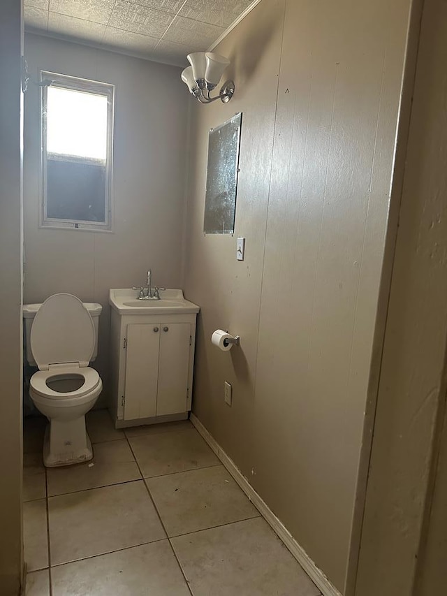 bathroom featuring vanity, tile patterned floors, and toilet