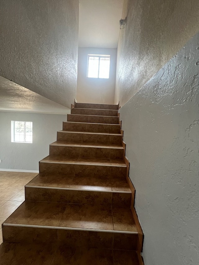 stairway with tile patterned floors