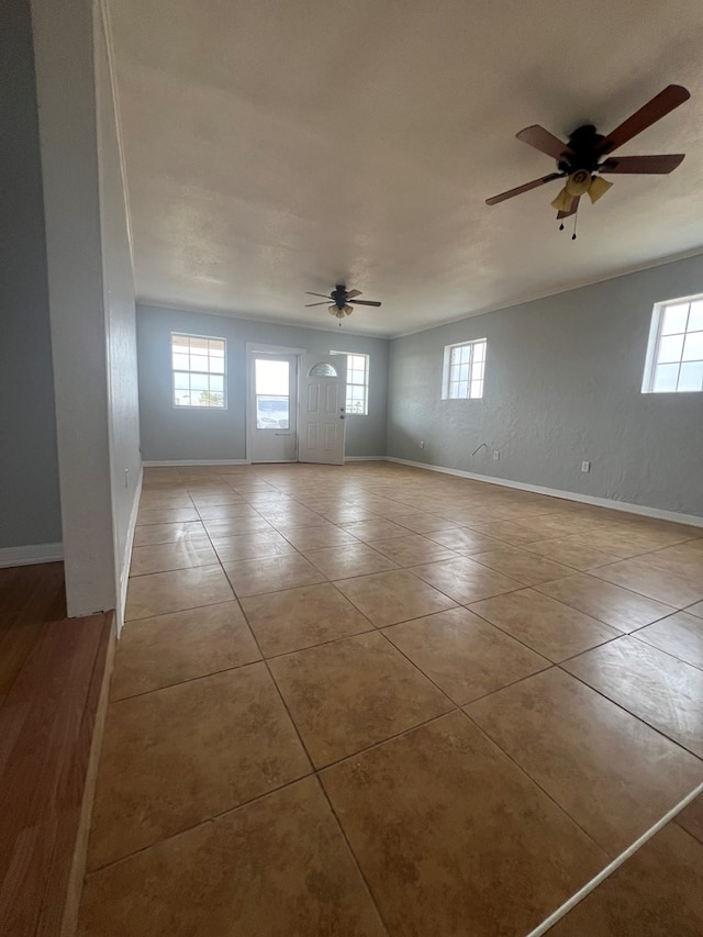 spare room featuring ceiling fan and light tile patterned floors