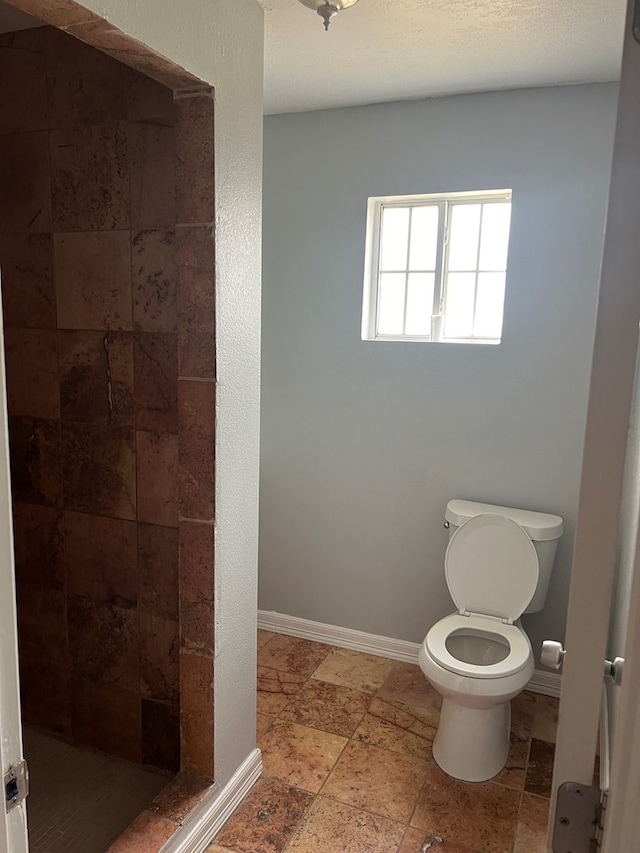 bathroom featuring a shower and toilet