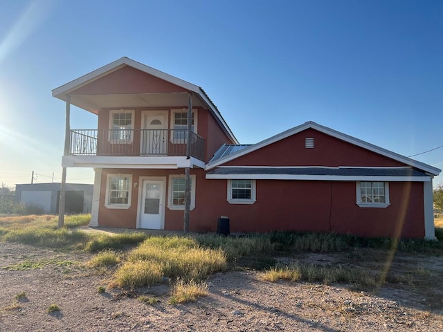 rear view of property with a balcony