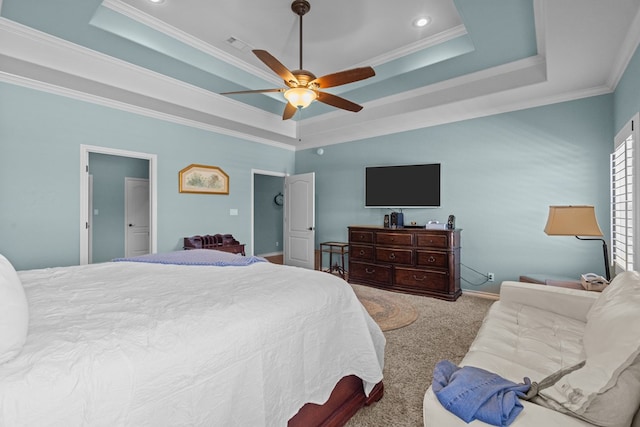 bedroom with a raised ceiling, ornamental molding, and carpet flooring