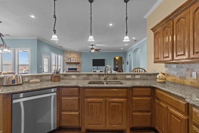 kitchen featuring light stone countertops, a sink, dishwasher, decorative light fixtures, and brown cabinets