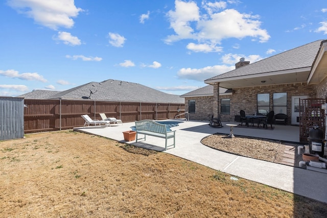 exterior space with a patio area and a fenced backyard