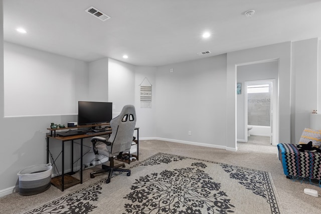 carpeted office space featuring recessed lighting, visible vents, and baseboards