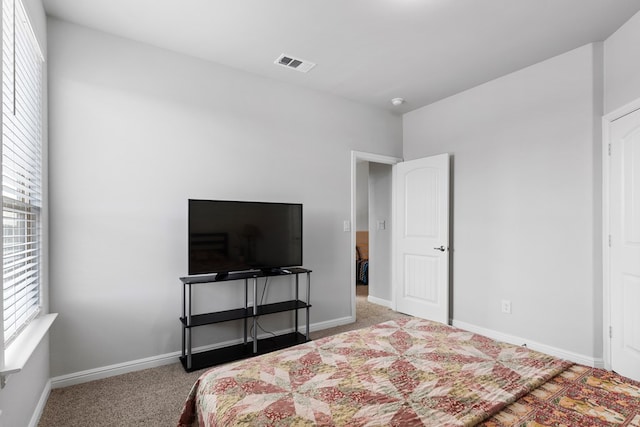 carpeted bedroom with visible vents and baseboards