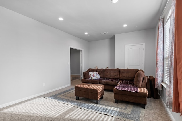 carpeted living room with recessed lighting, visible vents, and baseboards