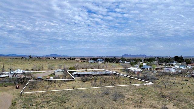 birds eye view of property with a mountain view and a rural view