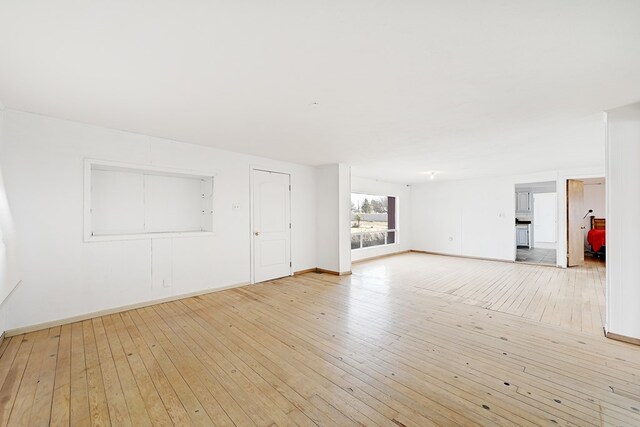 unfurnished living room with light wood-type flooring