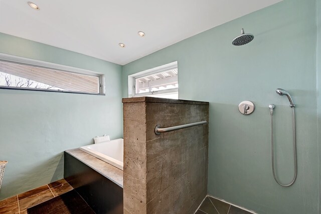 bathroom featuring tile patterned floors and shower with separate bathtub