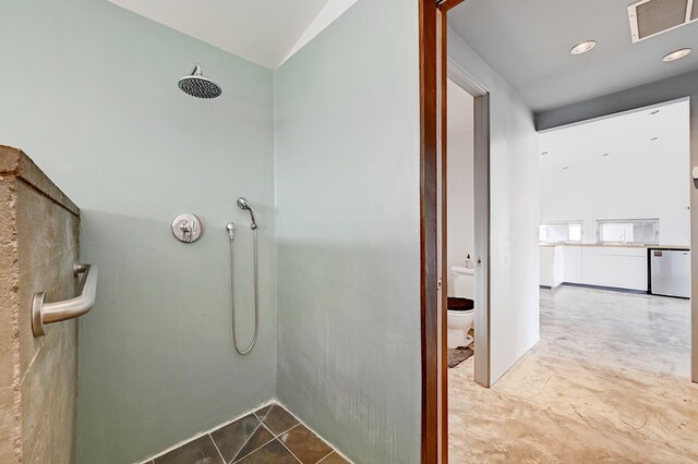 bathroom with tile patterned floors, toilet, and walk in shower