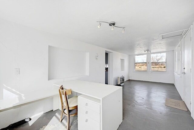 home office featuring built in desk and heating unit