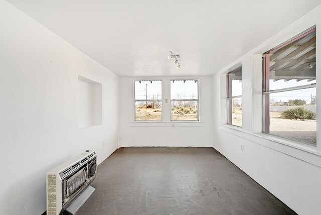 unfurnished sunroom featuring heating unit