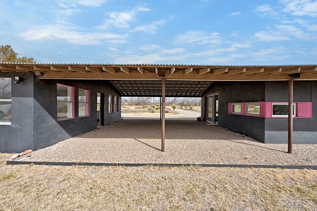 view of parking / parking lot featuring a carport