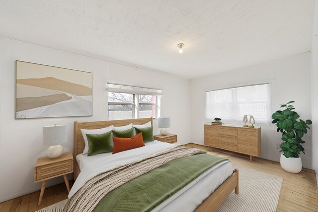 bedroom featuring a textured ceiling and light wood-type flooring