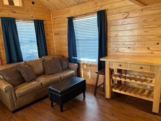 living room featuring hardwood / wood-style floors, plenty of natural light, wooden ceiling, and wood walls