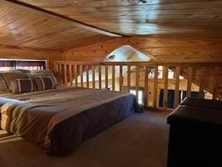 carpeted bedroom with lofted ceiling and wood ceiling