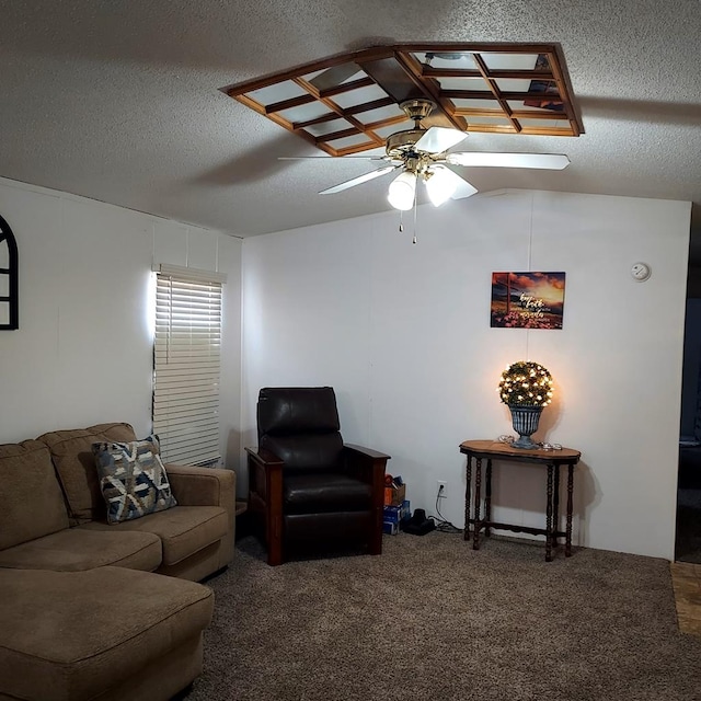 living room with ceiling fan, carpet floors, and a textured ceiling