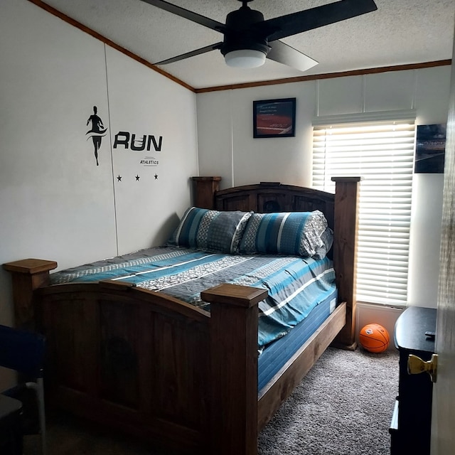 carpeted bedroom with ceiling fan, ornamental molding, and a textured ceiling