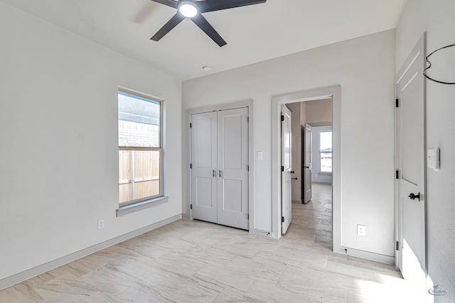 unfurnished bedroom featuring a closet and ceiling fan