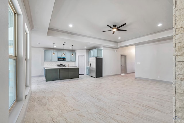 unfurnished living room with a tray ceiling, a stone fireplace, and ceiling fan