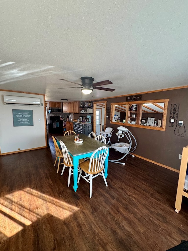 dining space with a textured ceiling, baseboards, wood finished floors, and a wall mounted air conditioner