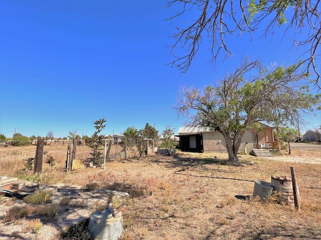 view of yard with a rural view