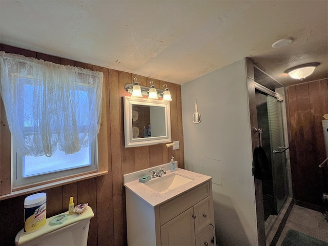 bathroom featuring vanity, toilet, an enclosed shower, and wood walls