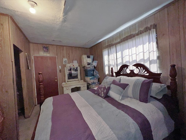 bedroom featuring wooden walls