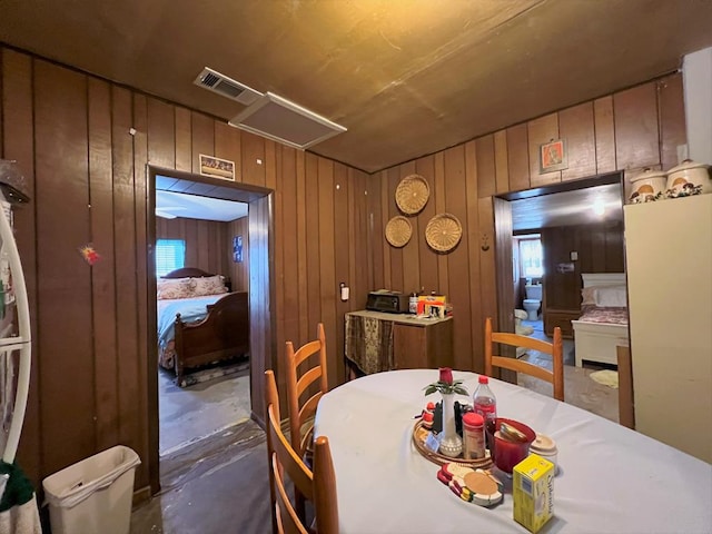 dining space with wooden walls