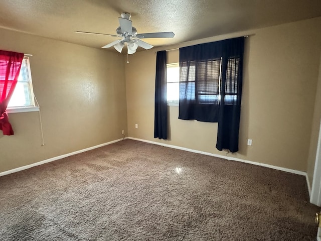 spare room featuring a ceiling fan, carpet, a textured ceiling, and baseboards