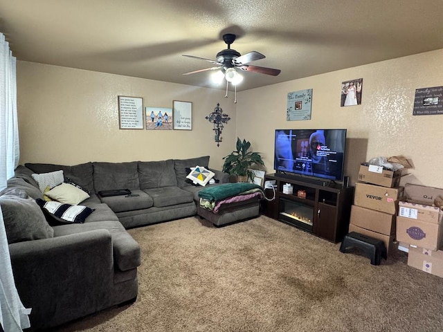 carpeted living room with a textured ceiling and ceiling fan