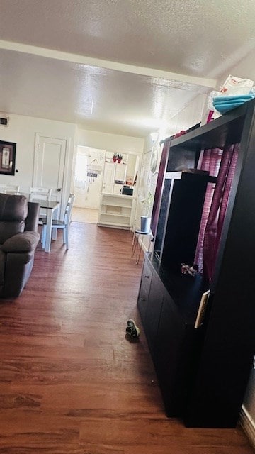 living room with dark hardwood / wood-style flooring and a textured ceiling