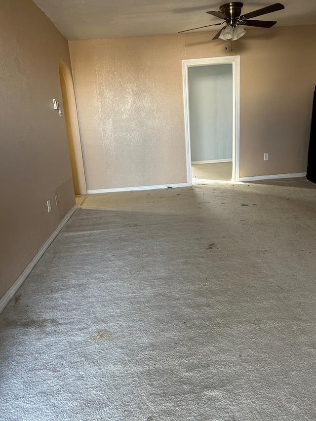 carpeted empty room with ceiling fan