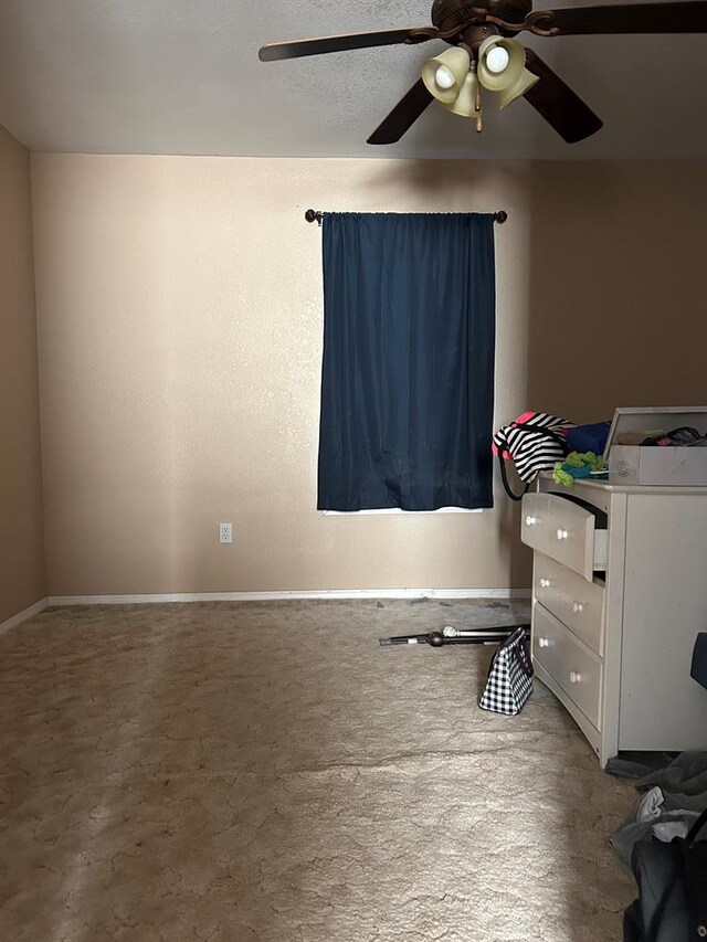 spare room with carpet and ceiling fan