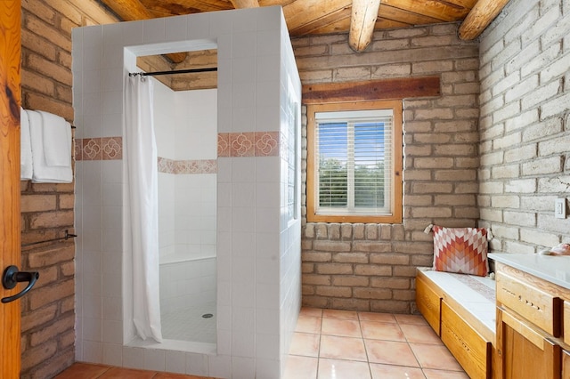 bathroom with tile patterned flooring, brick wall, and a shower with curtain