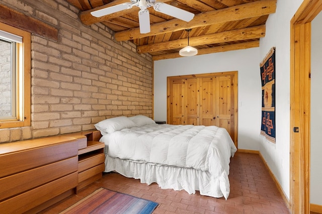 bedroom with wood ceiling, brick wall, and beamed ceiling