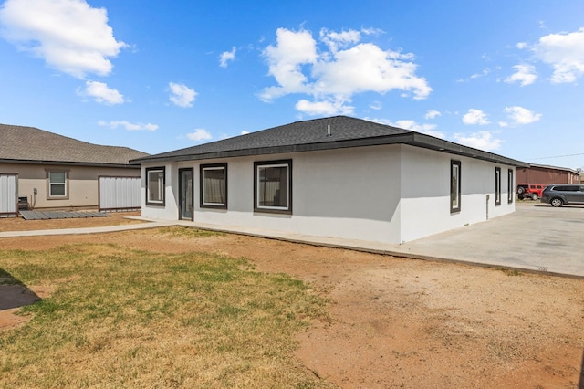 back of property with a patio and a yard