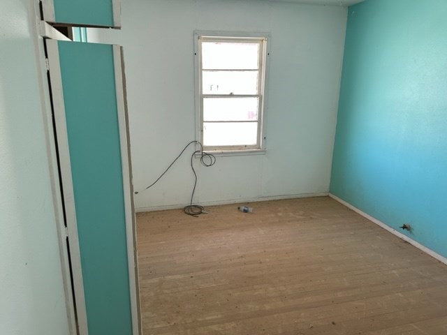 empty room with light hardwood / wood-style flooring