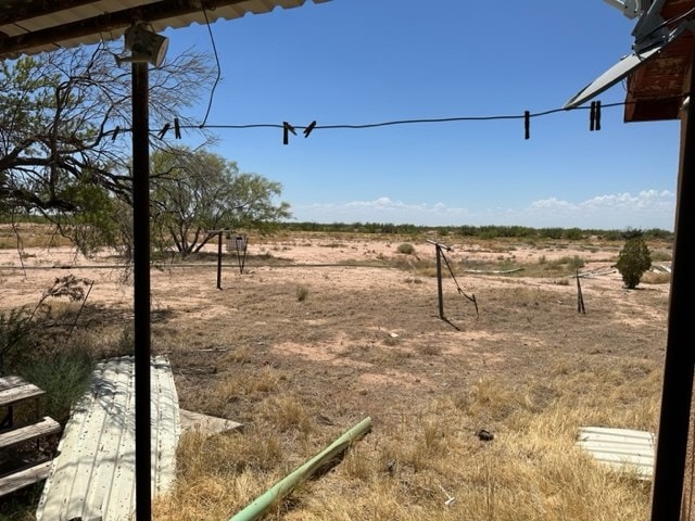 view of yard with a rural view