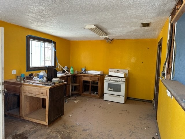 miscellaneous room with a workshop area and a textured ceiling