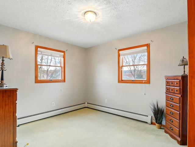 702/704 S Wilbur Ave, Sayre, PA 18840 - unfurnished bedroom featuring light colored carpet, multiple windows, a baseboard radiator, and a textured ceiling