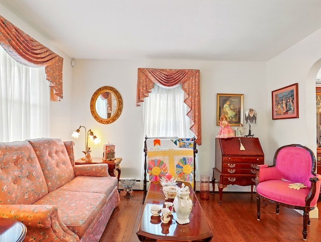 702/704 S Wilbur Ave, Sayre, PA 18840 - living room featuring arched walkways, wood finished floors, and baseboard heating
