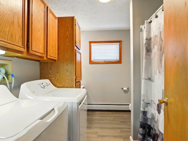 702/704 S Wilbur Ave, Sayre, PA 18840 - laundry room featuring washing machine and clothes dryer, a baseboard heating unit, light wood-style floors, a textured ceiling, and cabinet space